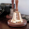 9 inch tall polished finish brass and wood hand bell with optional logo engraving and round walnut display base