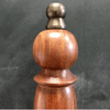 Closeup of finial on top of hand bell handle
