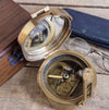 Antiqued brass military compass with cover open showing mirror in cover reflecting open compass dial
