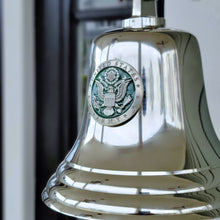  Closeup of 7 inch polished nickel finish brass wall bell showing green and silver pewter army logo medallion