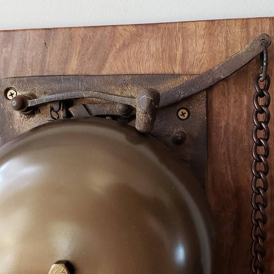 Closeup of pull chain and ring mechanism on large brass ringside boxing bell