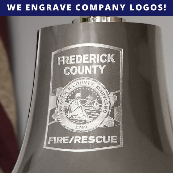 Closeup of personalized logo engraving featuring a fire and rescue department on the front of a large nickel plated brass deluxe memorial bell