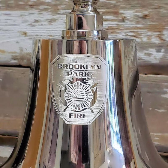 Closeup of optional logo engraving on front of nickel memorial bell featuring fire department logo