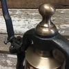 Closeup of antiqued finish solid brass finial on medium size railroad bell