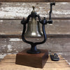 Medium antiqued finish solid brass and cast iron railroad bell with four lines of personalized text engraving on a deluxe walnut wood base