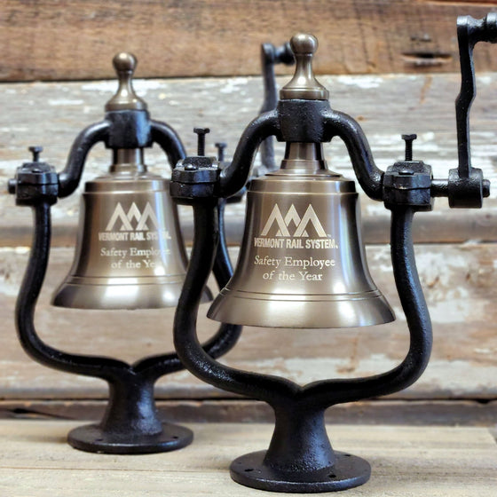 Two medium antiqued finish solid brass and cast iron railroad bells engraved with rail company logo and text