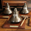 Three antiqued brass medium stock market bells with wood hammers and optional customer logo engraving and brass plate