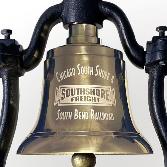 Closeup of optional customer logo engraving on front of polished brass railroad bell