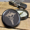 Antiqued brass finish three inch diameter working compass with engraved medical Cardecus on front lid 
