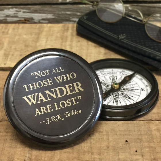 Three inch diameter antiqued brass compass with Tolkien quote "Not all those who wander are lost" engraved on front