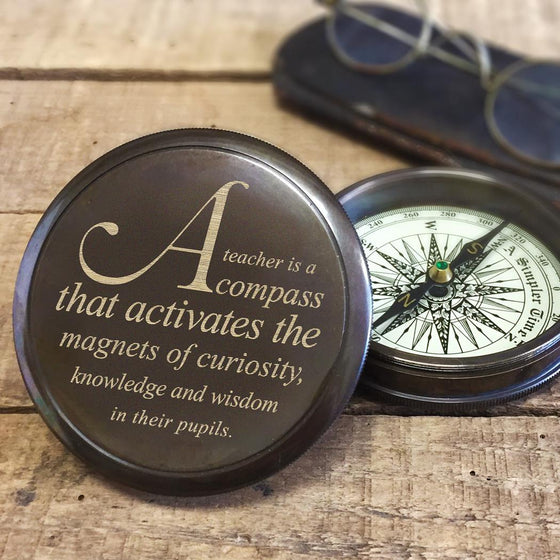3 inch diameter antiqued brass working compass with quote about teachers being a compass engraved on lid