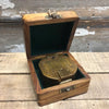 Antiqued brass military compass shown in wood display case box
