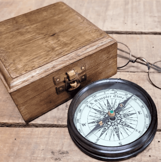 Bottom half of 3 inch antiqued brass wright brothers compass with compass rose and floating needle, plus wood display box
